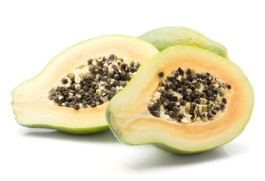 Papaya (pawpaw, papaw) isolated on white background one whole and two sliced halves with orange flesh and seeds.