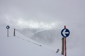 one way sign on snow mountains 