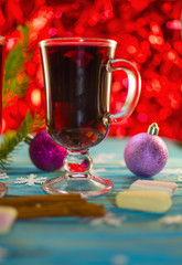 A hot drink of mulled wine and spices on a wooden background