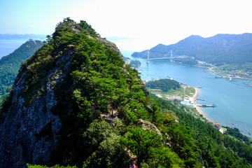 Rocky mountain peak, islands and misty sea