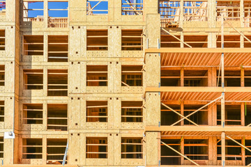 Wooden framework of brand new low-rise building on sunny day