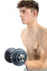 Fototapeta na wymiar 18 Year old teenage boy lifting weights