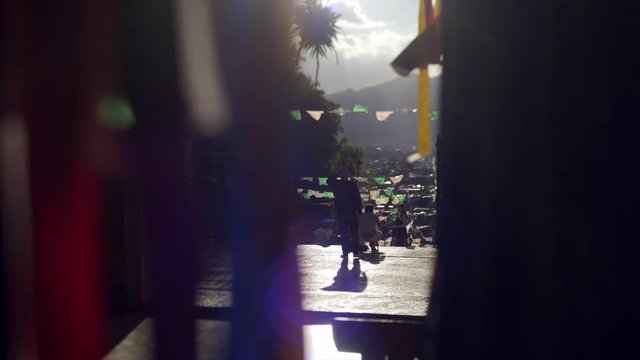 view through colorful ribon to people enter Guadalupe church in ancient town  San Cristobal de las Casas
