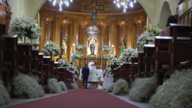 15 February 2017 Mexico, San Cristobal de las Casas. moving camera,wedding ceremony in chatolic church, just-married couple in front of altar, church in ancient town San Cristobal de las Casas
