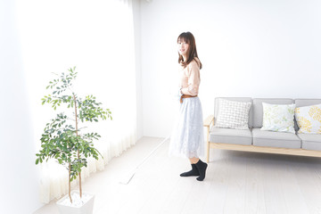 Young woman cleaning her room