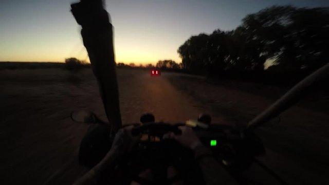 gopro shot of person driving dune buggy in the dark on dirtroad
