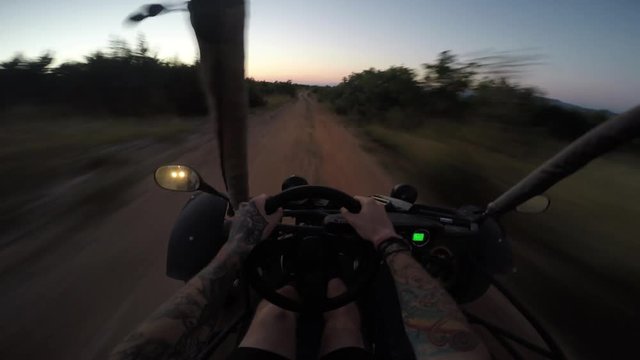 gopro shot of person driving dune buggy in the dark during sunset
