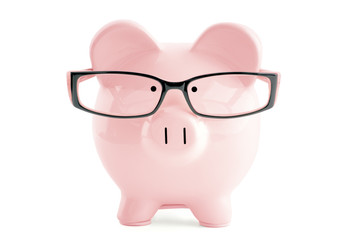 Pink piggy bank in in glasses  isolated on white