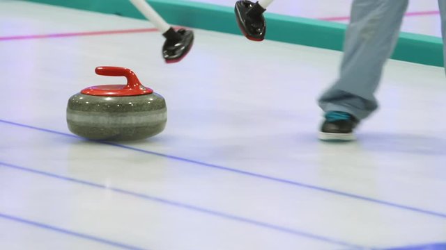 Curling. Stone slides on ice