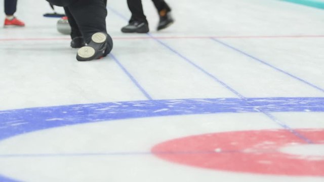 Curling. Stone slides on ice