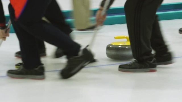 Curling. Stone slides on ice