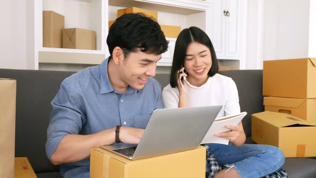 Young Asian People Working at home, Young Owner People Strat up for Business Online, SME, Delivery Project, People with Online Business or SME Concept. Woman Note Order from Customer. 