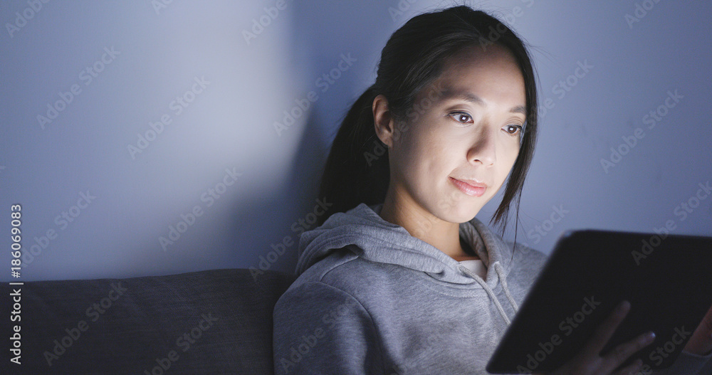 Canvas Prints Woman use of tablet computer at night