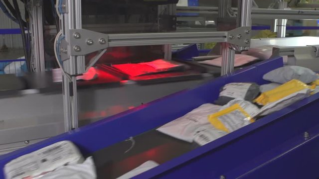 Logistics mail center, parcels traveling on conveyor belt