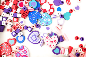 Colorful wooden beads on a white background. hearts,