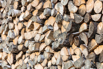 pile of chopped firewood ready for winter. stack of wood logs.