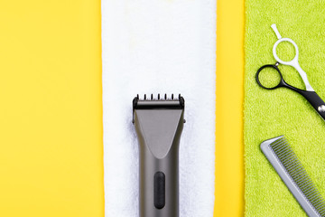 the things of the hairdresser on clean towels lie on the yellow background of the table