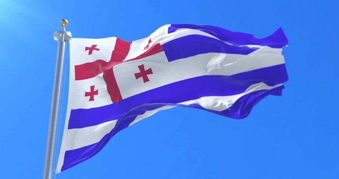Adjara flag waving at wind in slow with blue sky, loop