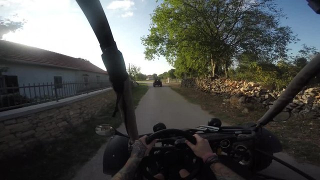 Gopro shot of young man driving dune buggy on the street
