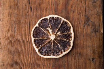 Fototapeta na wymiar Dried orange on a wooden table