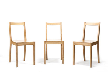 three solid wood chairs isolated the white background.