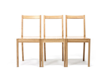three solid wood chairs isolated the white background.