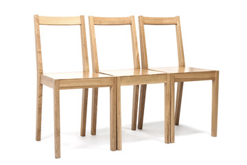 three solid wood chairs isolated the white background.