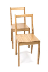 two solid wood chairs isolated the white background.