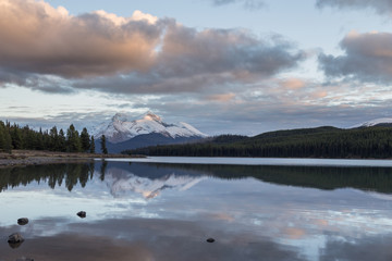 Maligne Lake at sunset time with Maligne Mountain in the distance.