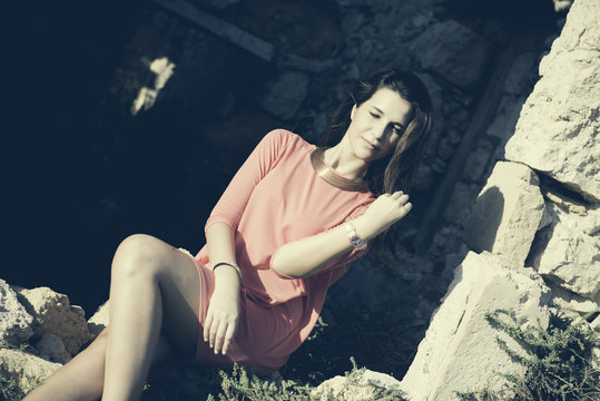 Close up of a 18Y old Girl Sitting in a Window of a Ruined House (location: Plemmirio Natural Park, Siracusa in Sicily)
