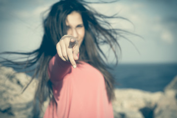 Hey you!. Close up of a 18Y old girl in a rural location indicating the observer 