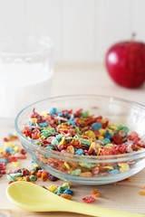 Colorful rice cereal with milk and red apple for children. Healthy quick breakfast.