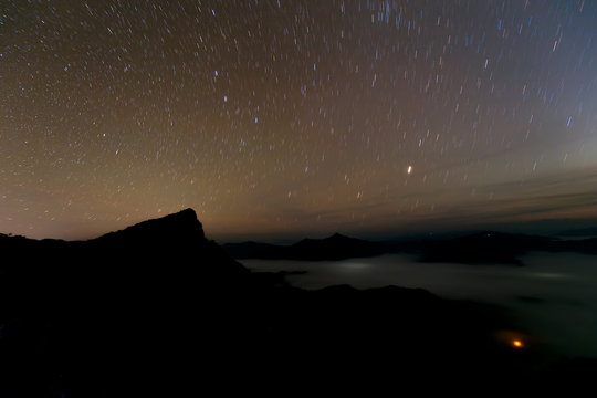 Landscape of Mountains at Night with Stars Trails in Thailand
