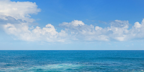 Tropical ocean, beach, high waves and blue sky.