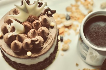 chocolate cake on the white plate with a cup of coffee, food macro photography decoration concept for new year party.