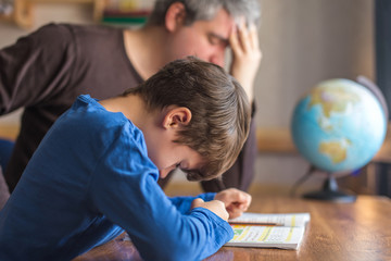 Sad father tired about sons failure on mathematics homework