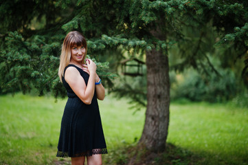 Portrait of gorgeous girl wear on black at hen party, posed at park.