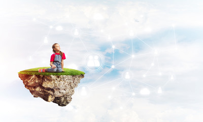 Concept of careless happy childhood with girl dreaming about something