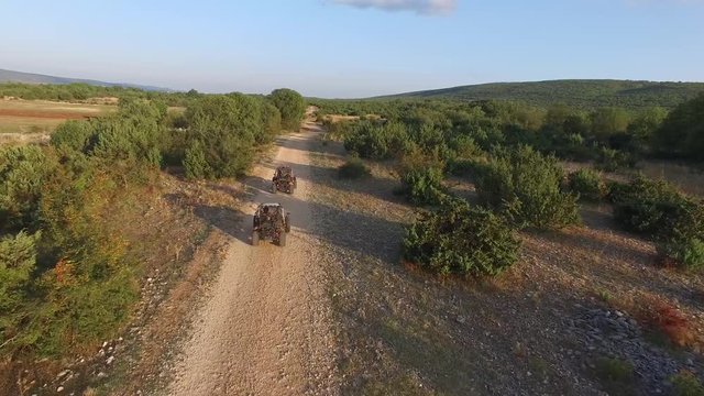 Drone shot of dune buggies driving on offroad on a dirt road in Croatia