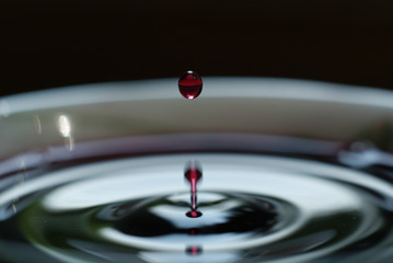 a drop in white Cup on black background