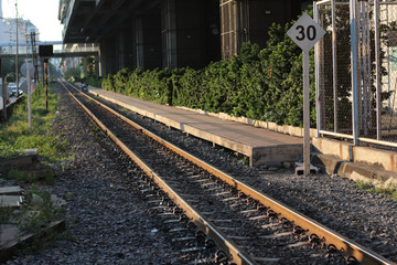 Railroad tracks in Bangkok Thailand with light sunset in evening