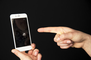 The cracked screen is in the hand