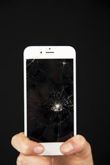 The cracked screen is in the hand