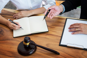 business people and lawyers discussing contract papers sitting at the table. Concepts of law, advice, legal services