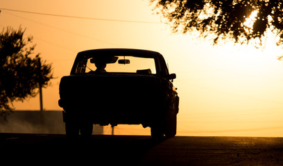 Fototapeta na wymiar car rides on the road at sunset