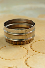 Pastry being cut with a metal cutter