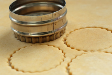 Pastry being cut with a metal cutter