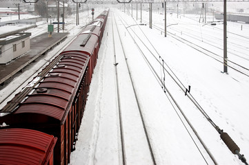 Top view of freight train with carriages on railways at winter. Selectuve focus