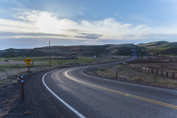 Fototapeta premium winding road in nature by the field