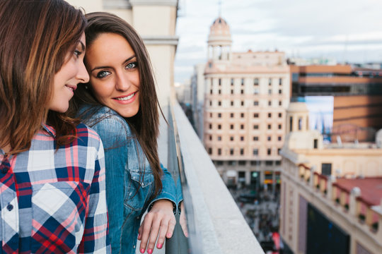 Two Cute Girls Having Fun in a City Viewpoint